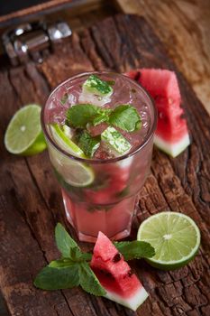 Homemade watermelon lemonade with mint and lime in glasses and slices of watermelon