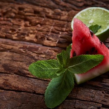 Watermelon, mint and lime with copy space on the wooden background