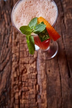 glass watermelon and orange smoothie with copy space on wooden background