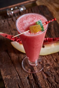 Healthy watermelon and melon smoothie with copy space on a wood background