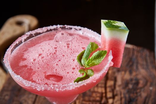 Watermelon frozen cocktail with copy space on wooden background