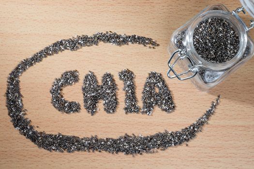 chia word made from chia seeds on wooden plate
