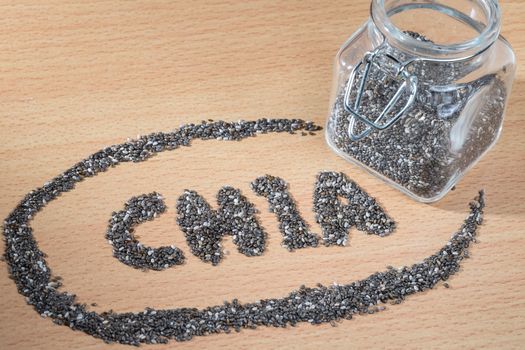 chia word made from chia seeds on wooden plate