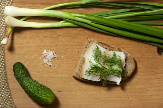 Sandwich with salted lard on rye bread served with green onion and garlic