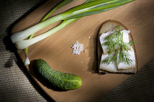 Sandwich with salted lard on rye bread served with green onion and garlic