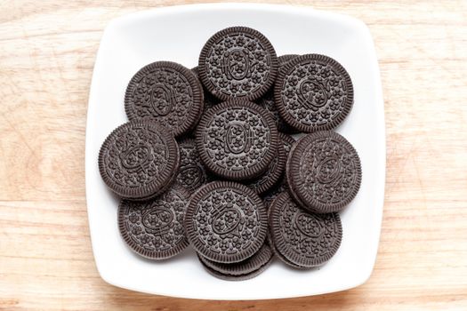 group of black cookie and cream in white ceramic dish. Look very tasty.