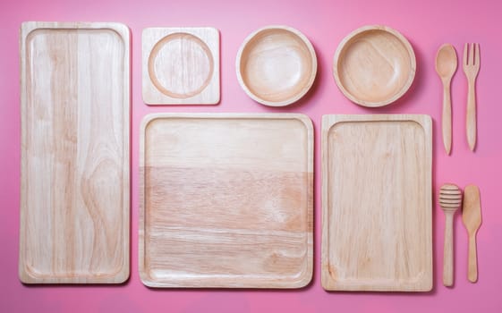 Group of wooden plate and bowl on pink background