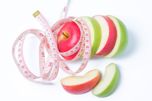 slice red and green apples with waist measure on white background
