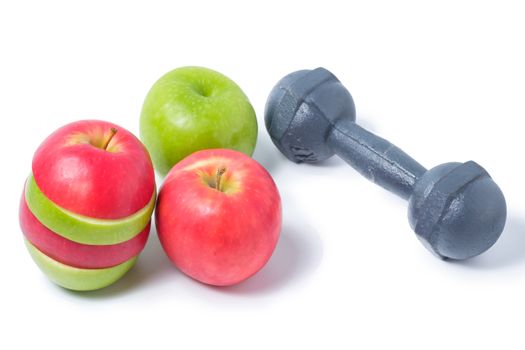 slice red and green apples with dumbbell on white background