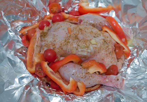 Chicken baked in foil with vegetables. Preparation for cooking.