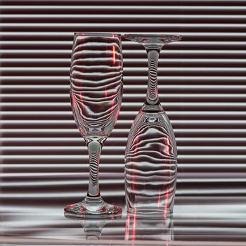 Two empty glasses with bands of reflection blinds