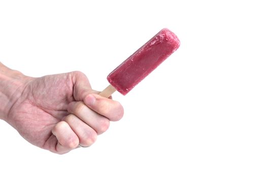 A man's hand holding a grape ice pop on a white background.