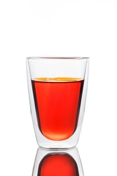 Glass of red water, like a tomato juice, carrot juice, soft drink
