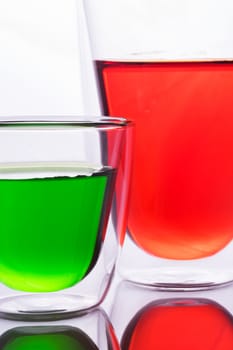 Glass of red and green  water, like a tomato juice, carrot juice, soft drink, vegetable juice,