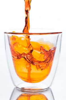 pouring orange water in to clear two layers glass, this orange water look like whisky, spirits