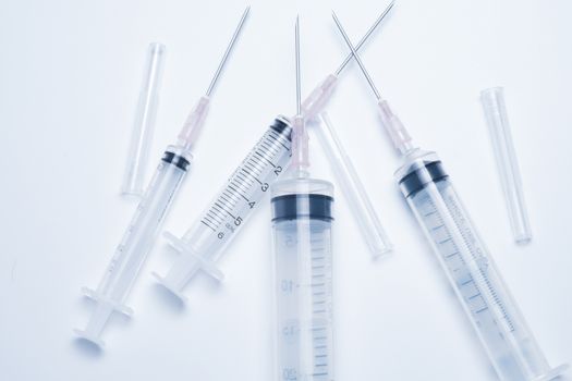 syringes on white background. this photo in cold mood tone.