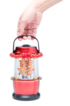 Hand holding Chinese LED lantern lamp with golden Chinese double happiness symbol sign called "shuang xi"