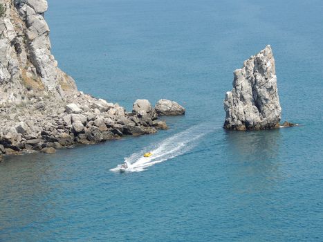 View of the Black Sea from a lock platform the Swallow's nest on the peninsula of Crimea. Rest on the Black Sea coast. Southern coast of Crimea. Sail rock in Gaspra.