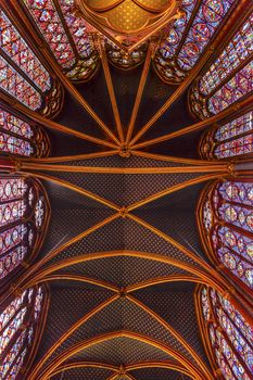Stained Glass Cathedral Ceiling Saint Chapelle Paris France.  Saint King Louis 9th created Sainte Chappel in 1248 to house Christian relics, including Christ's Crown of Thorns.  Stained Glass created in the 13th Century and shows various biblical stories along wtih stories from 1200s.