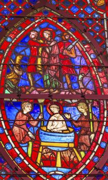 Knights Peasants Attempt to Boil Saint John In Oil Stained Glass Saint Chapelle Paris France.  Saint King Louis 9th created Sainte Chappel in 1248 to house Christian relics, including Christ's Crown of Thorns.  Stained Glass created in the 13th Century and shows various biblical stories along wtih stories from 1200s.