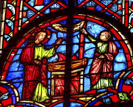 Jesus with Woman at Well Stained Glass Saint Chapelle Paris France.  Saint King Louis 9th created Sainte Chapelle in 1248 to house Christian relics, including Christ's Crown of Thorns.  Stained Glass created in the 13th Century and shows various biblical stories along with stories from 1200s.
