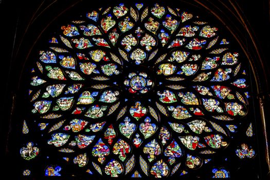 Jesus Christ With Sword Biblical and Medieval Stories Rose Window Stained Glass Saint Chapelle Paris France.  Saint King Louis 9th created Sainte Chappel in 1248 to house Christian relics, including Christ's Crown of Thorns.  Stained Glass created in the 13th Century and shows various biblical stories along wtih stories from 1200s.