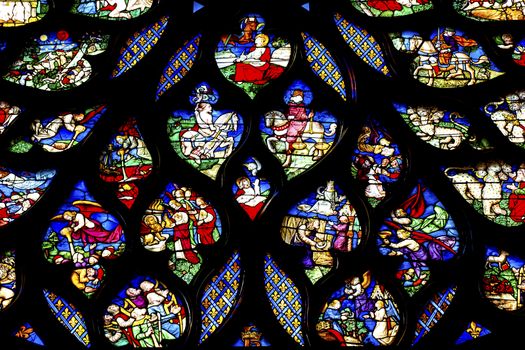 Biblical Medieval Stories Horses Angels  Rose Window Stained Glass Saint Chapelle Paris France.  Saint King Louis 9th created Sainte Chappel in 1248 to house Christian relics, including Christ's Crown of Thorns.  Stained Glass created in the 13th Century and shows various biblical stories along wtih stories from 1200s.