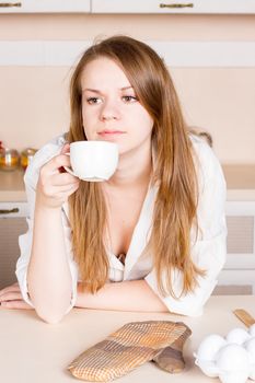 Woman drinking tea in the kitchen. Close frame