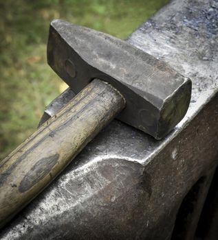 background old forging hammer on the anvil