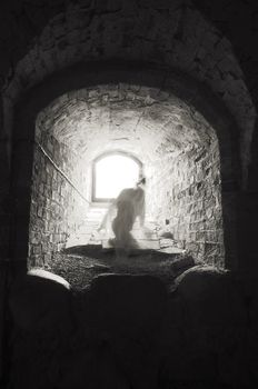 Headless ghost trying to get away from the light in medieval castle.