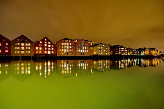 Houses on the water at night in Trondheim, Norway