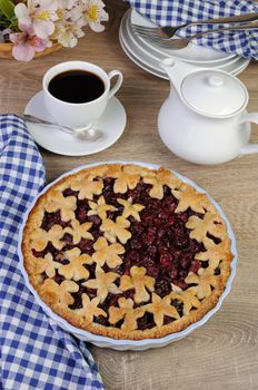 pie with cherry filling decorated flowers and petals  