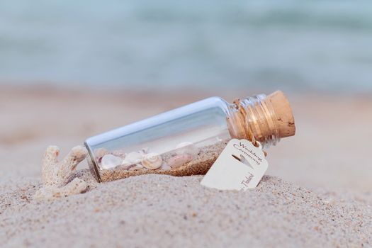 Sand and sea shell in bottle  put on the beach concept for wedding invitation or wedding gift venue on the beach .