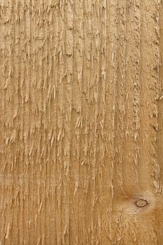 Rough wooden surface of a pine fence post as an abstract background texture 