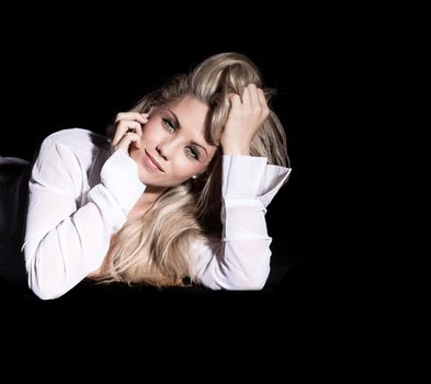 portrait of beautiful blonde woman on black background