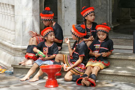 CHIANGMAI, THAILAND - 5 July 2015 : Unidentified hill tribe kids  relax from dance show for donation at Doi Suthep Temple, Chiangmai, north of Thailand.