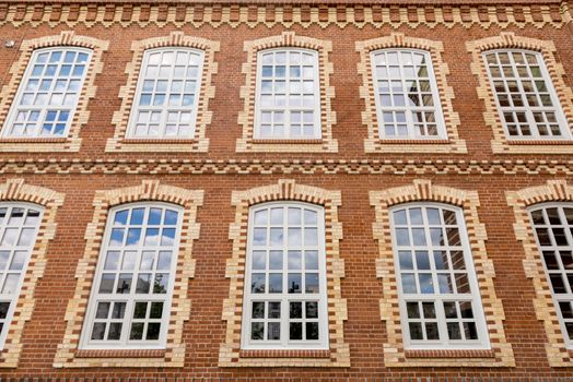 Facade of an old office building of red brick