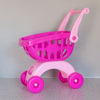 Pink shopping cart in a living room