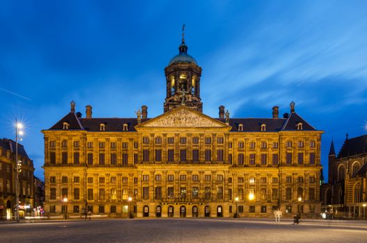 Amsterdam, Netherlands - May 7, 2015: People visit Royal Palace at Dam Square in Amsterdam, Netherlands. Its notable buildings and frequent events make it one of the most well-known and important locations in the city and the country.
