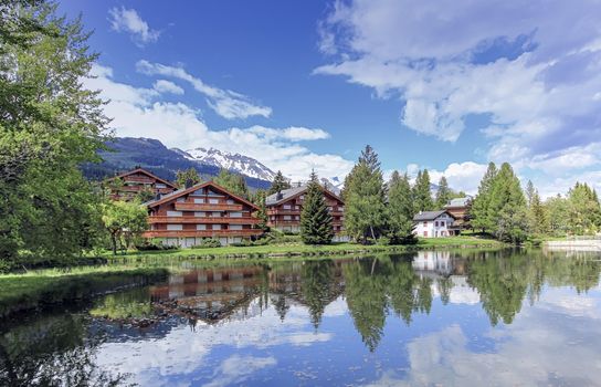 Chalets and lake at Crans-Montana by beautiful day, Valais, Switzerland