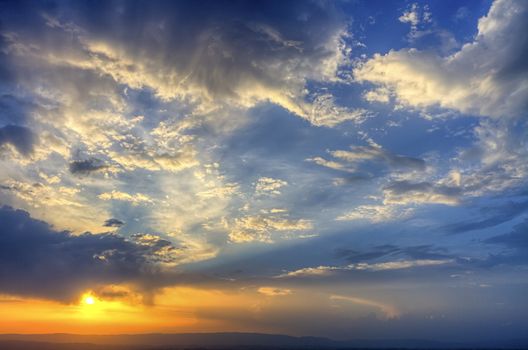 Dramatic colorful sunset in the cloudy sky