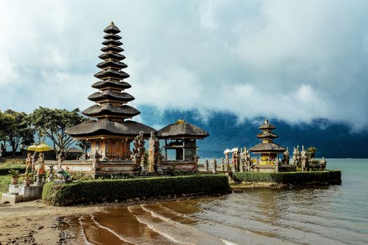 Most famous Pura Ulun Danu water temple on a lake Beratan. Bali, sunny evening with mist