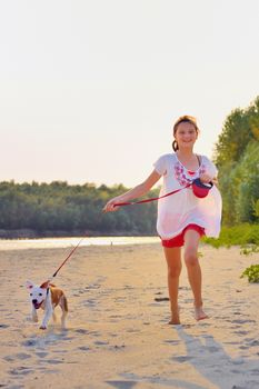 Girl playing with dog on beach