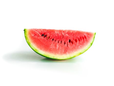 Isolated piece of watermelon with seeds visible on white background, quarter sideview, healthy eating, sweet summer refreshment