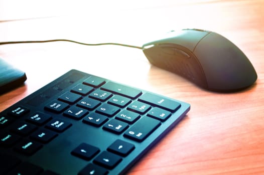 Computer mouse and keyboard on the office table. Computer technology conceptual image.