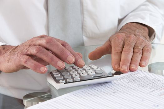 close-up picture of a business man using calculator