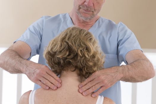 Doctor massaging his patient neck in medical office