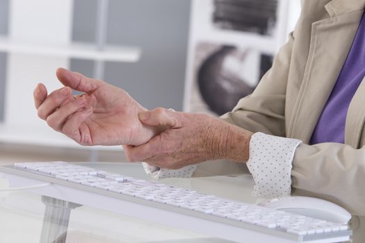 Hands with RSI syndrome over the keyboard of laptop computer