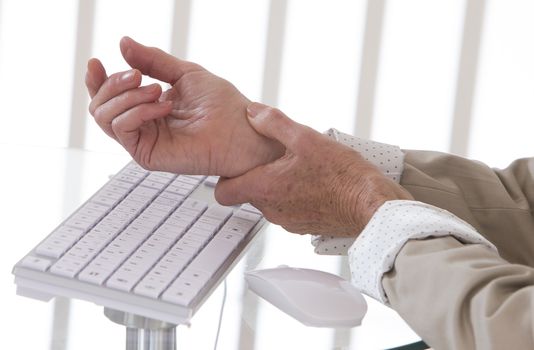 Hands with RSI syndrome over the keyboard of laptop computer