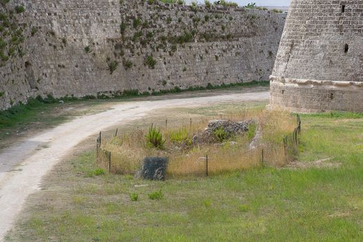 courtyard of the castle of Otranto with small dirt track